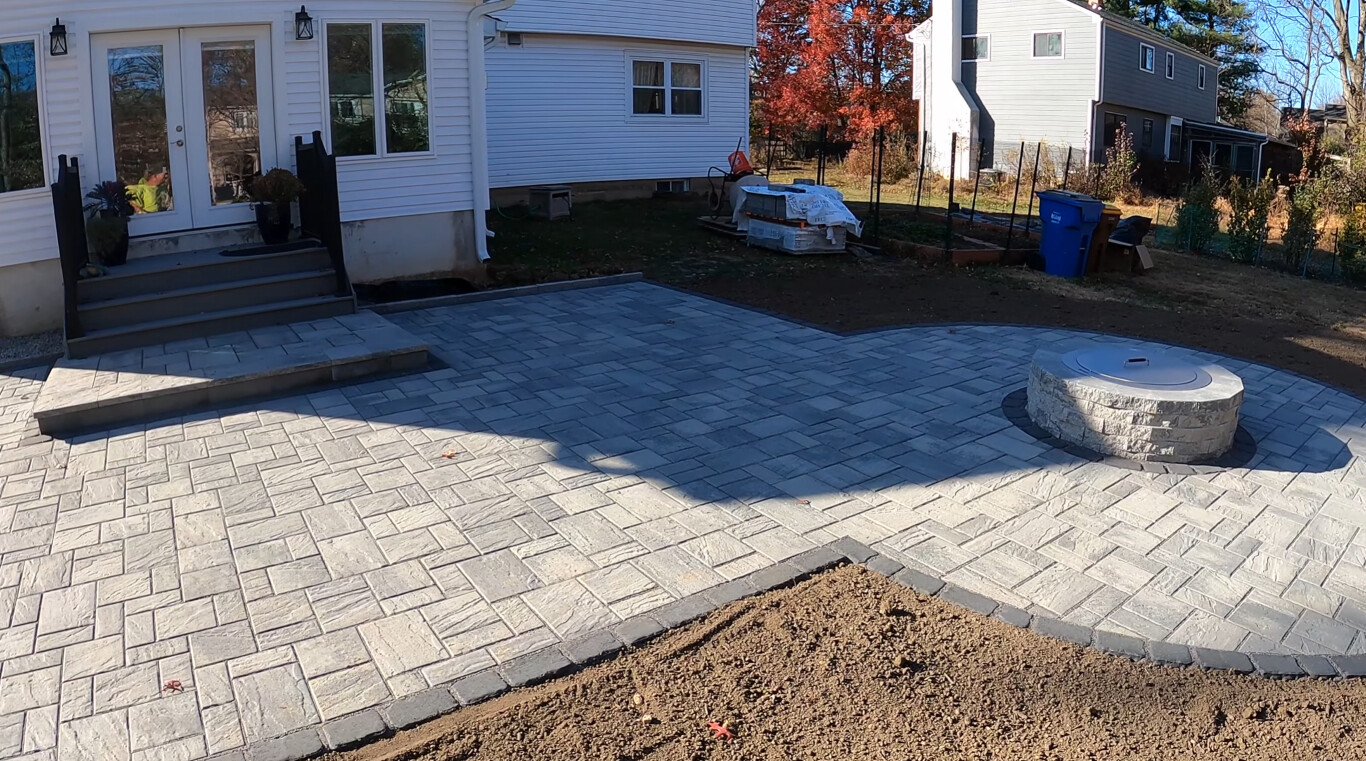 Premium stamped concrete patio with herringbone pattern and fire pit in Franklin, TN